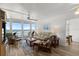 Cozy living room featuring comfortable seating, ceiling fan, and ocean views from sliding glass doors at 5201 S Atlantic Ave # 708A, New Smyrna Beach, FL 32169