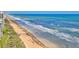 Aerial view of the beach with an ocean view and beach access at 5499 Atlantic # 104, New Smyrna Beach, FL 32169