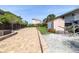 Paved driveway leads up to the house, adjacent to shed and lush landscaping at 6260 S Atlantic Ave, New Smyrna Beach, FL 32169