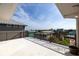 A balcony with a metal railing, a view of the neighborhood, and a large open space at 6260 S Atlantic Ave, New Smyrna Beach, FL 32169