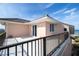A balcony with a railing and an ocean view with a sliding glass door accessing the residence at 6260 S Atlantic Ave, New Smyrna Beach, FL 32169