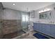Bathroom boasting a glass-enclosed shower with bench, vanity with double sinks, and modern fixtures at 6260 S Atlantic Ave, New Smyrna Beach, FL 32169