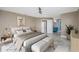 A calming bedroom featuring light tan walls, and ensuite bathroom access for added convenience at 6260 S Atlantic Ave, New Smyrna Beach, FL 32169