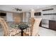 Dining area with a glass table, wicker chairs, wet bar, and a ceiling fan at 6260 S Atlantic Ave, New Smyrna Beach, FL 32169