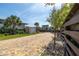 Paver driveway with a shed on the left, grass on the left and a fence on the right at 6260 S Atlantic Ave, New Smyrna Beach, FL 32169