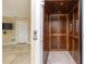 Interior of a wooden elevator next to a doorway and tiled floor at 6260 S Atlantic Ave, New Smyrna Beach, FL 32169