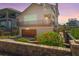 Beautiful two-story home with a balcony, lush landscaping, and a brick wall in a coastal community at 6260 S Atlantic Ave, New Smyrna Beach, FL 32169