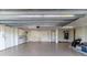An empty garage that is well lit, has epoxy flooring, and storage cabinets at 6260 S Atlantic Ave, New Smyrna Beach, FL 32169