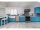Modern kitchen with a farmhouse sink, stainless steel appliances, and a custom wood range hood at 6260 S Atlantic Ave, New Smyrna Beach, FL 32169