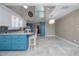 Bright kitchen with island seating, nautical decor, and a chandelier in an open, airy space at 6260 S Atlantic Ave, New Smyrna Beach, FL 32169