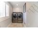 Efficient laundry room featuring side-by-side washer and dryer with cabinets for storage at 6260 S Atlantic Ave, New Smyrna Beach, FL 32169