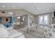 Open living space features comfortable white seating, views of the kitchen and a dining area, and coastal decor at 6260 S Atlantic Ave, New Smyrna Beach, FL 32169