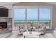 Cozy living room with ocean views from large windows, comfortable seating, and a fireplace with marble surround at 6260 S Atlantic Ave, New Smyrna Beach, FL 32169