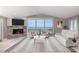Inviting living room boasts stylish furnishings, ocean views, and a fireplace with an eye-catching accent wall at 6260 S Atlantic Ave, New Smyrna Beach, FL 32169