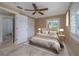 Bedroom with a ceiling fan, neutral decor, ensuite bathroom and walk-in closet at 6260 S Atlantic Ave, New Smyrna Beach, FL 32169