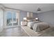 Bedroom with a ceiling fan and slider doors leading to a balcony with an ocean view at 6260 S Atlantic Ave, New Smyrna Beach, FL 32169
