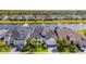 Aerial view of a well manicured and landscaped home with a pond in the backyard at 6277 W Fallsgrove Ln, Port Orange, FL 32128