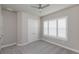 Bright bedroom with a ceiling fan, closet, gray carpet, and white shutters on the window at 6277 W Fallsgrove Ln, Port Orange, FL 32128