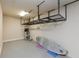 Spacious garage with ceiling rack, surfboard, and water heater at 6277 W Fallsgrove Ln, Port Orange, FL 32128