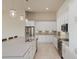 Spacious kitchen featuring a large island, stainless appliances, and pendant lights at 6277 W Fallsgrove Ln, Port Orange, FL 32128