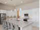 Gourmet kitchen with white cabinetry, stainless appliances, and large island at 6277 W Fallsgrove Ln, Port Orange, FL 32128
