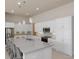 Gourmet kitchen with a large island, stainless steel appliances, and white cabinets at 6277 W Fallsgrove Ln, Port Orange, FL 32128