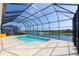 Beautiful screened-in pool offering stunning views of the surrounding lake and community at 6277 W Fallsgrove Ln, Port Orange, FL 32128