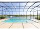 Screened-in pool offers a tranquil view of the lake with a fountain at 6277 W Fallsgrove Ln, Port Orange, FL 32128