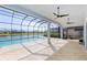 Stunning screened-in lanai with a beautiful pool overlooking the serene lake and lush landscaping at 6277 W Fallsgrove Ln, Port Orange, FL 32128