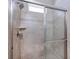 Beautiful tiled shower with glass door and brushed nickel shower head at 6277 W Fallsgrove Ln, Port Orange, FL 32128