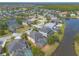 Aerial view of neighborhood with lake view homes, landscaping, mature trees, and pools at 6950 Vintage Ln, Port Orange, FL 32128