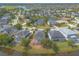 Aerial view of neighborhood featuring pond view homes with screened pools and mature trees at 6950 Vintage Ln, Port Orange, FL 32128