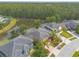 Aerial view of homes with backyard pools, mature trees, landscaping, and a lake at 6950 Vintage Ln, Port Orange, FL 32128