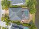 Overhead shot of a home's backyard and pool, with lush landscaping along the lake at 6950 Vintage Ln, Port Orange, FL 32128