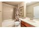 Bathroom with tub, shower, tiled walls, toilet, and vanity provides a functional space at 6950 Vintage Ln, Port Orange, FL 32128
