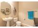 Cozy half bathroom featuring a pedestal sink, a toilet, and neutral wall paint at 6950 Vintage Ln, Port Orange, FL 32128