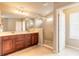 A luxurious bathroom features a double vanity, shower, and tile flooring for a spa-like retreat at 6950 Vintage Ln, Port Orange, FL 32128
