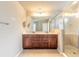 A spacious bathroom with double vanities and a glass-enclosed shower for a modern, clean design at 6950 Vintage Ln, Port Orange, FL 32128