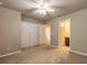 Bedroom boasts carpet floors, a ceiling fan, and a spacious closet with double doors at 6950 Vintage Ln, Port Orange, FL 32128