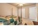 Bedroom includes a four-poster bed, a ceiling fan, and a closet with double doors at 6950 Vintage Ln, Port Orange, FL 32128