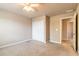 Carpeted bedroom with closet and door to the hallway provides a functional space at 6950 Vintage Ln, Port Orange, FL 32128