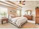 A serene main bedroom features a tray ceiling, plush carpeting and furnishings, and bright, natural light at 6950 Vintage Ln, Port Orange, FL 32128