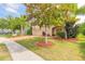 Inviting two-story home with a well-manicured lawn, a brick driveway, and mature landscaping, radiating curb appeal at 6950 Vintage Ln, Port Orange, FL 32128
