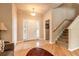 Welcoming foyer with tile flooring, staircase, and natural light, creating a warm first impression at 6950 Vintage Ln, Port Orange, FL 32128