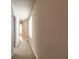 The hallway is well-lit with neutral walls and carpeting providing an inviting path through the home at 6950 Vintage Ln, Port Orange, FL 32128