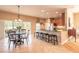 Bright kitchen and dining area with stainless steel appliances, granite countertops, and a cozy breakfast bar at 6950 Vintage Ln, Port Orange, FL 32128
