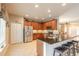 Well-lit kitchen with stainless steel appliances, granite countertops, and a convenient breakfast bar at 6950 Vintage Ln, Port Orange, FL 32128