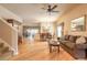 Open-concept living and dining area with hardwood floors, neutral paint, and stylish furnishings, perfect for entertaining at 6950 Vintage Ln, Port Orange, FL 32128