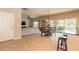 Open floor plan with tile floors, connecting the living room and dining area, with patio access at 6950 Vintage Ln, Port Orange, FL 32128