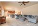 Bright open concept living area with a ceiling fan and views into kitchen and dining spaces at 6950 Vintage Ln, Port Orange, FL 32128